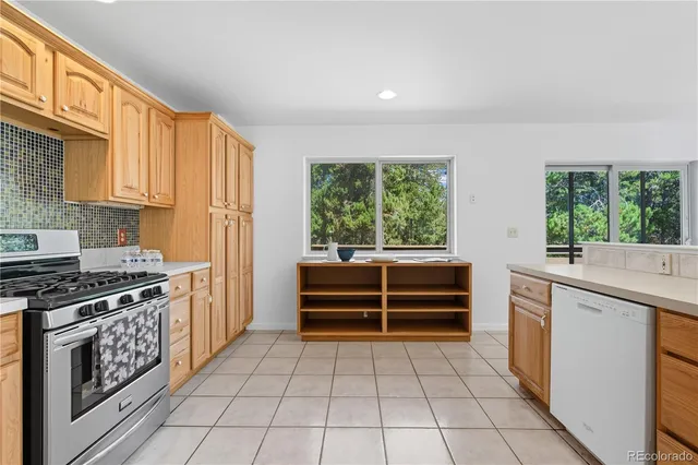 a kitchen with a stove a sink and a refrigerator