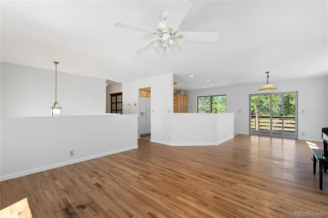 a view of empty room with wooden floor and fireplace