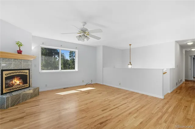 a view of empty room with a fireplace and windows