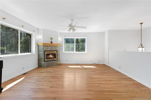 a view of an empty room with a ceiling fan