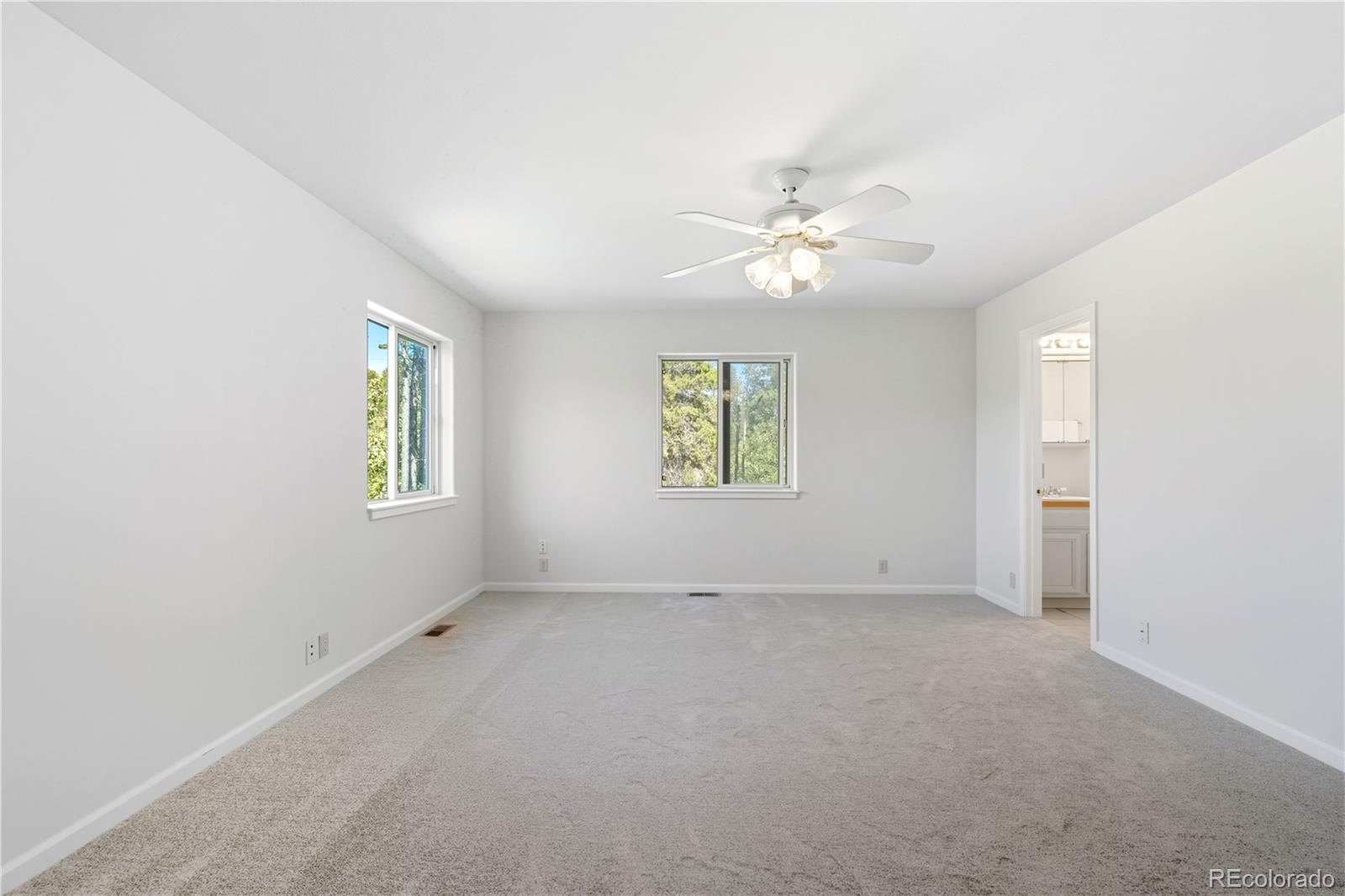 4 Gap Road Black Hawk, CO 80422 - Photo 21 of 43 an empty room with windows and ceiling fan