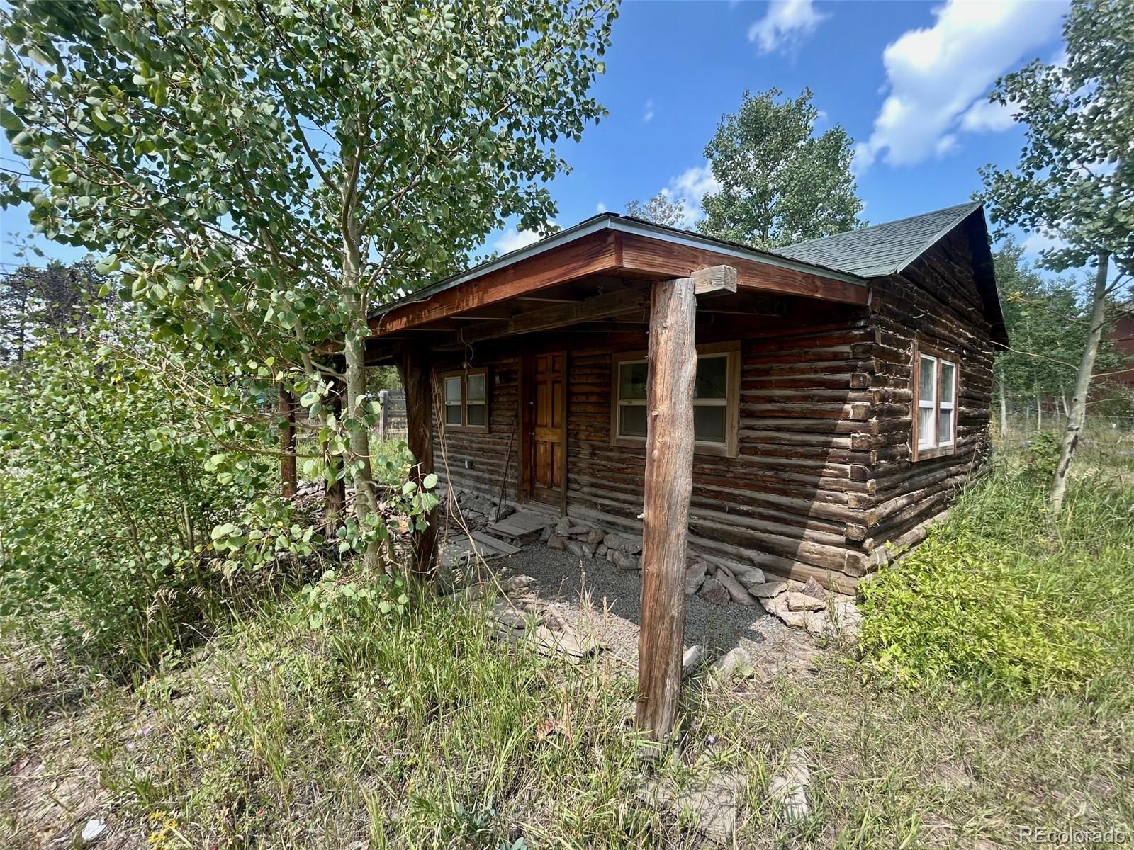 4 Gap Road Black Hawk, CO 80422 - Photo 38 of 43 a yellow house with trees in front of it