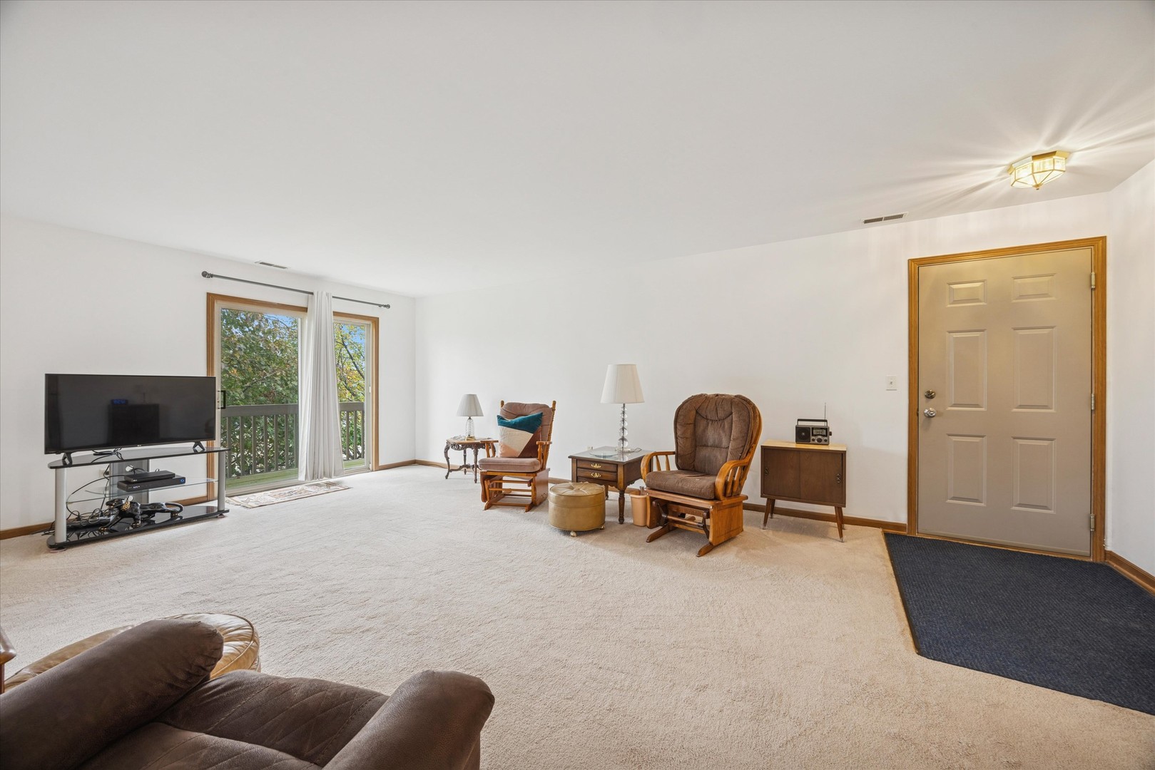2689 Jodee Drive, Unit B Joliet, IL 60436 - Photo 3 of 16 a living room with furniture gym equipment and a flat screen tv