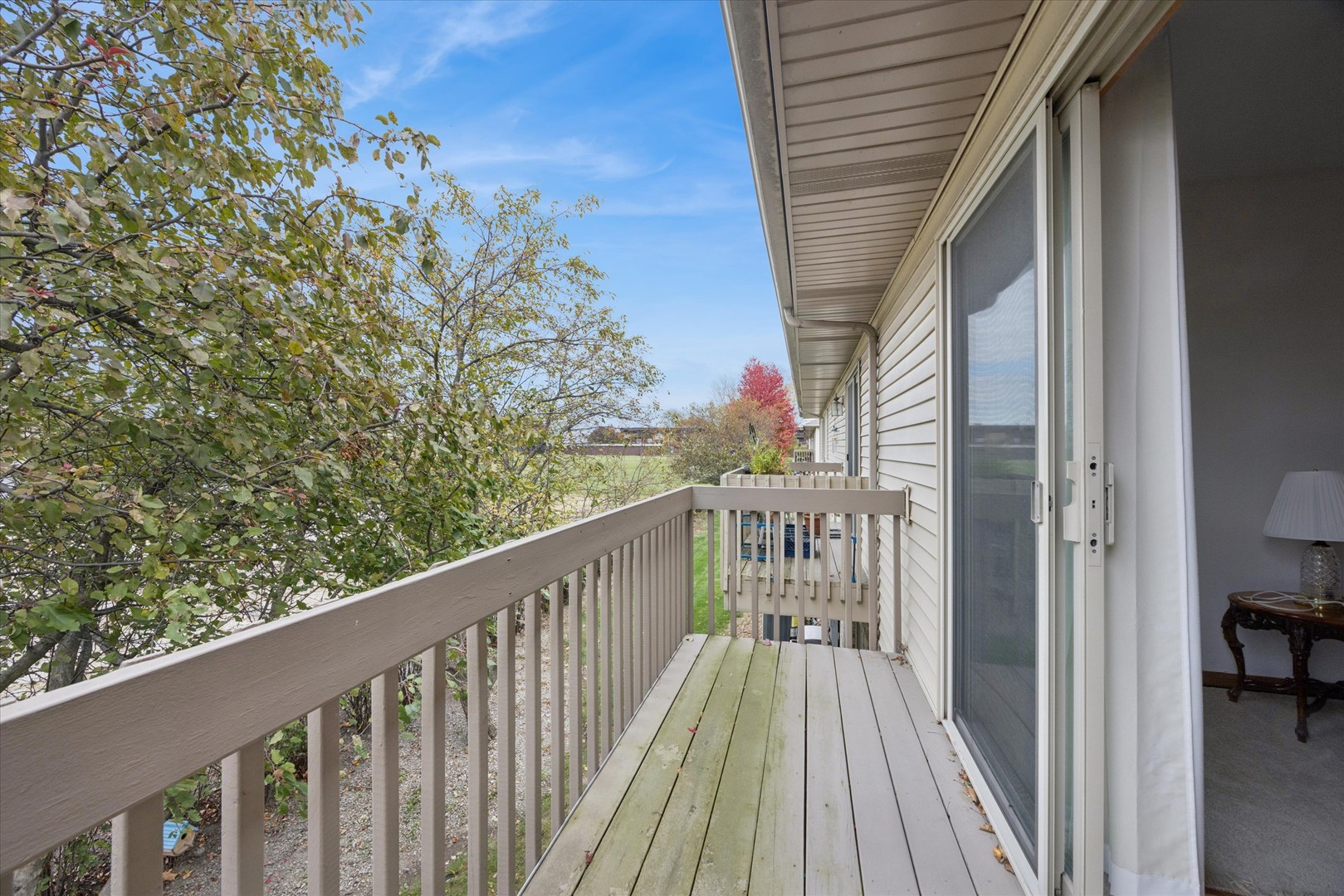 2689 Jodee Drive, Unit B Joliet, IL 60436 - Photo 6 of 16 a view of a balcony with wooden floor and fence