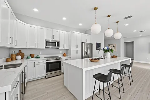a spacious en suite bathroom with a double vanity sink double vanity and mirrors