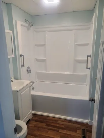 a bathroom with a shower and a toilet