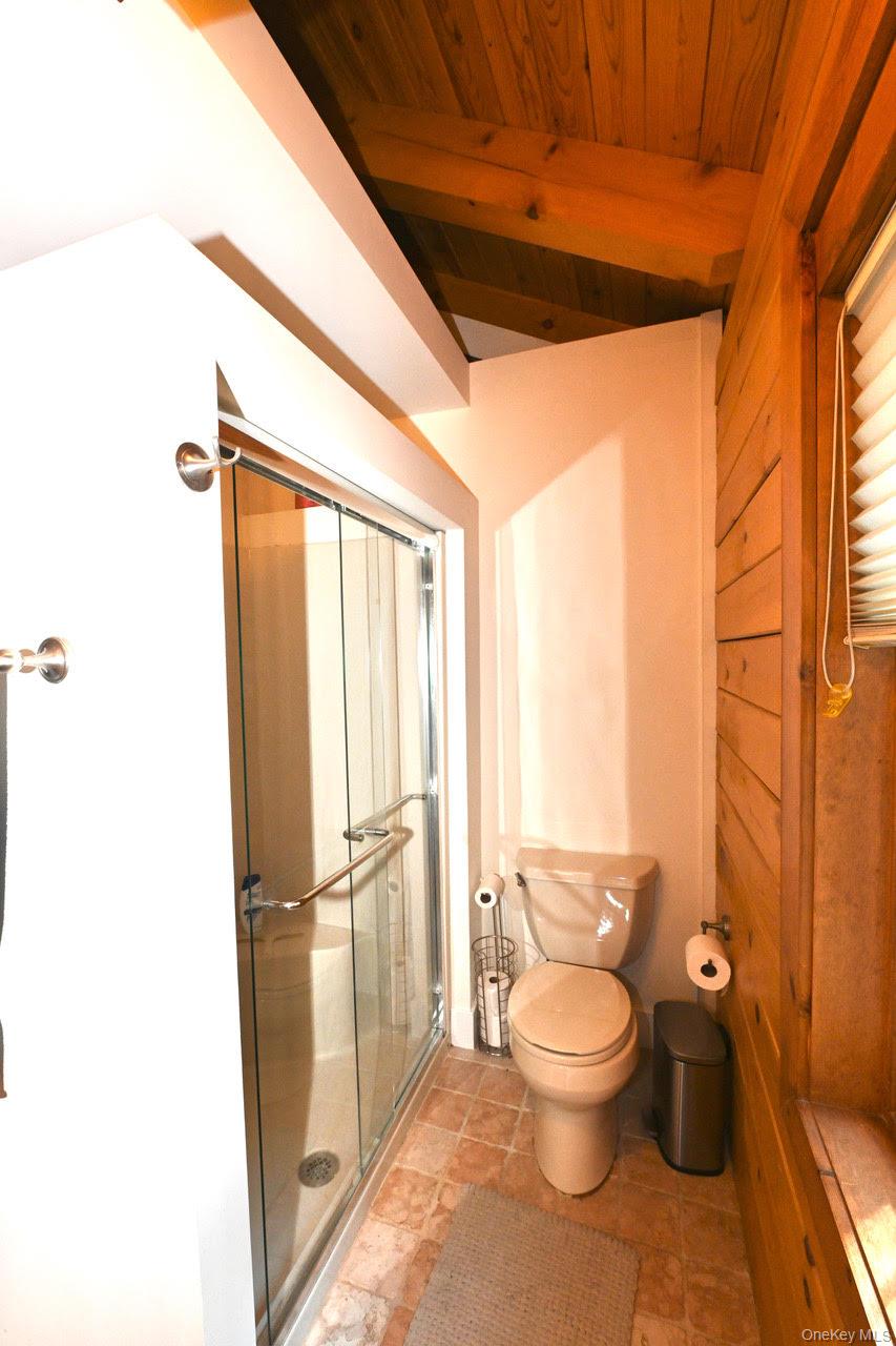 216 5th Street St. James, NY 11780 - Photo 17 of 21 Bathroom with a stall shower and a wooden ceiling with exposed beams