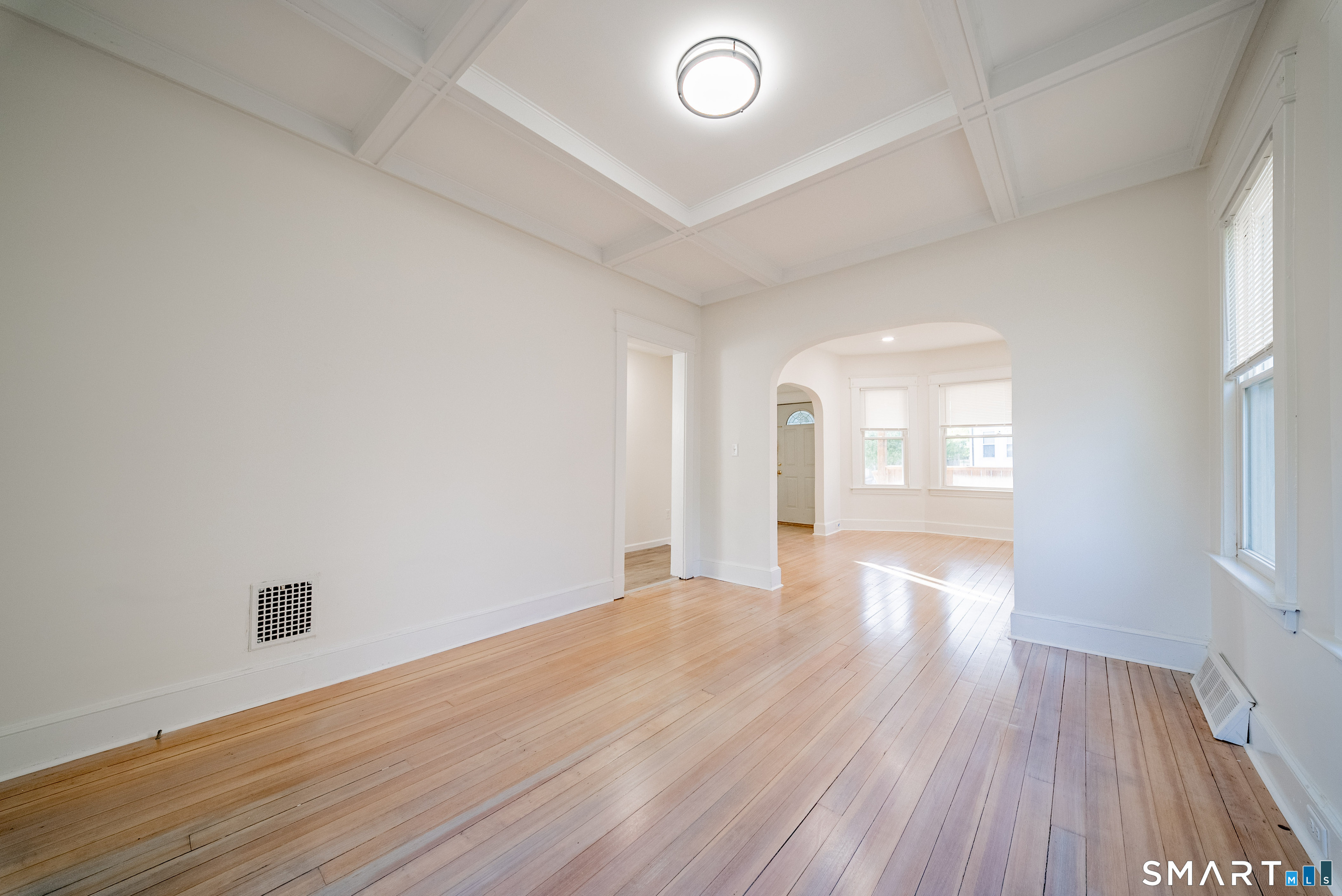 50 Jones Street West Haven, CT 06516 - Photo 7 of 21 a view of an empty room with wooden floor and a window