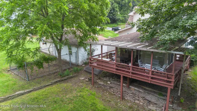 a small wooden bench sitting in the middle of a yard