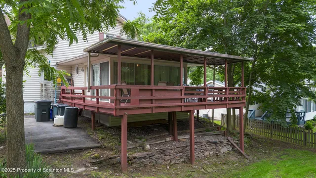 a backyard of a house with barbeque oven table and chairs
