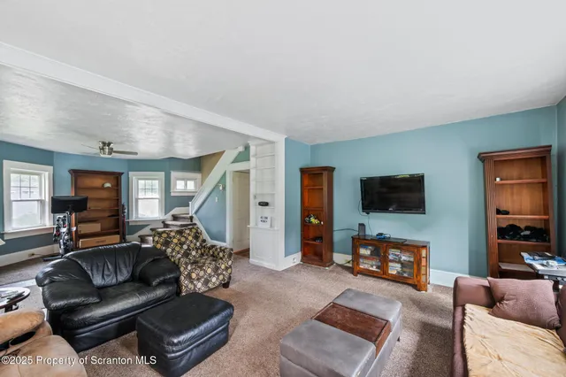 a view of a livingroom with furniture and a window