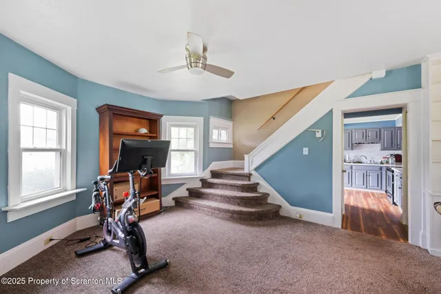 a view of a dining room with furniture and a chandelier