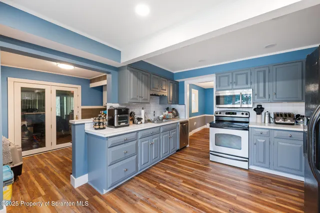 a kitchen with refrigerator and cabinets