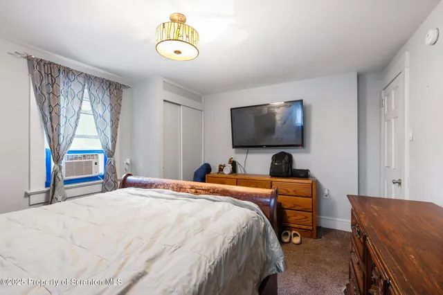 a view of a room with wooden floor and bathroom