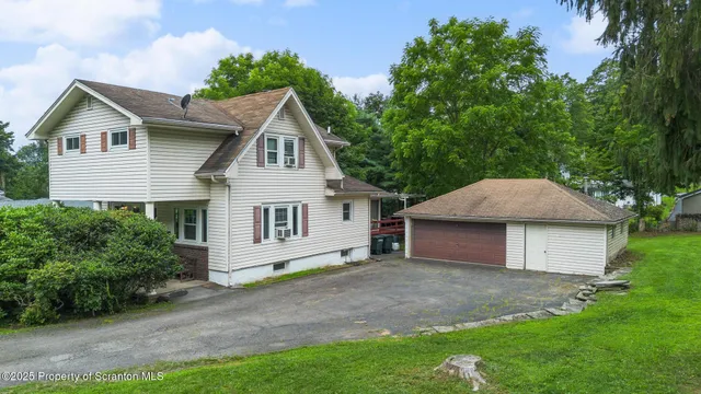a house that has a tree in front of it