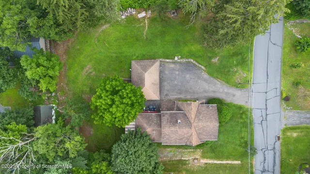 an aerial view of a house with a yard