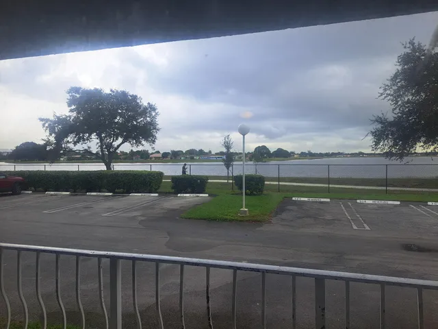 a view of a lake with table and chairs