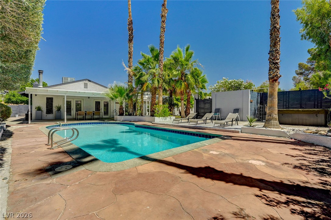 4153 Woodcrest Road Las Vegas, NV 89121 - Photo 51 of 58 A tranquil oasis awaits, complete with a sparkling swimming pool and ample space for relaxation.