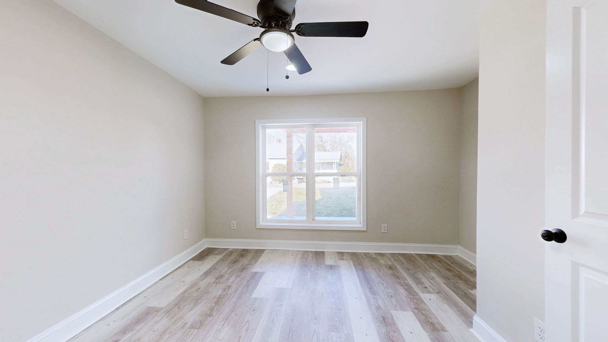 109 Wells Street Centerville, TN 37033 - Photo 14 of 19 an empty room with a window and a fan