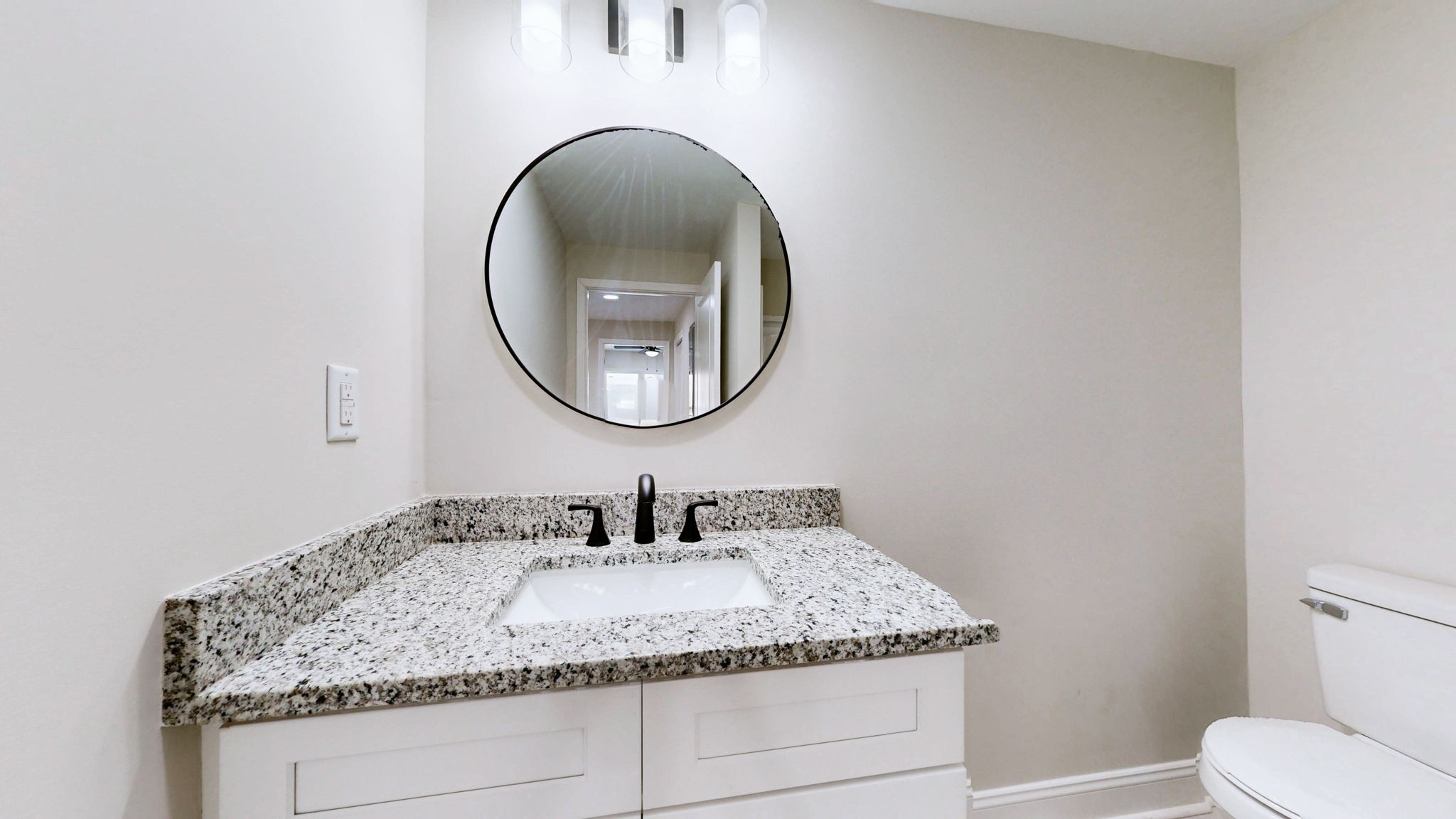 109 Wells Street Centerville, TN 37033 - Photo 15 of 19 a bathroom with a granite countertop toilet a sink and a mirror