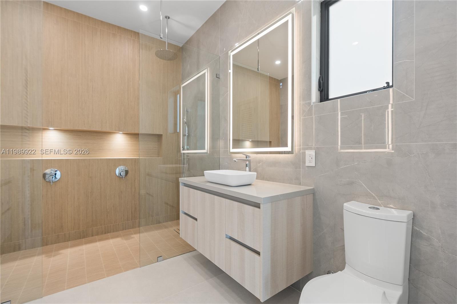 6221 Southwest 60th Street South Miami, FL 33143 - Photo 19 of 42 a bathroom with a sink a toilet and mirror