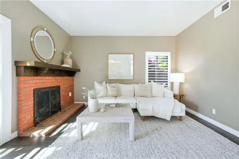 a living room with furniture a window and a fireplace