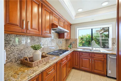 a kitchen with sink a window and cabinets
