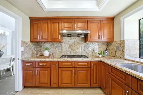 a kitchen with stainless steel appliances granite countertop a sink and cabinets