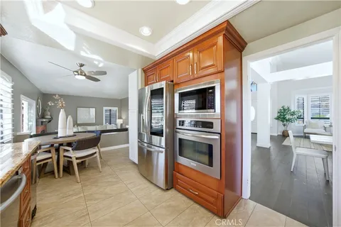 a kitchen with stainless steel appliances kitchen island granite countertop a refrigerator and a stove top oven