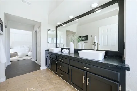 a spacious bathroom with a granite countertop sink and a bathtub