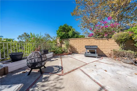 a view of a patio with table and chairs and potted plants