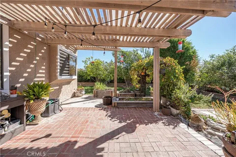 a view of backyard with a huge green area and wooden fence
