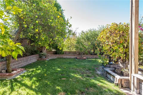 a view of a patio with table and chairs potted plants