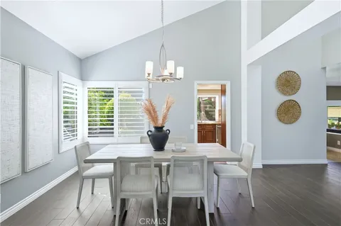 a view of a dining room with furniture and chandelier