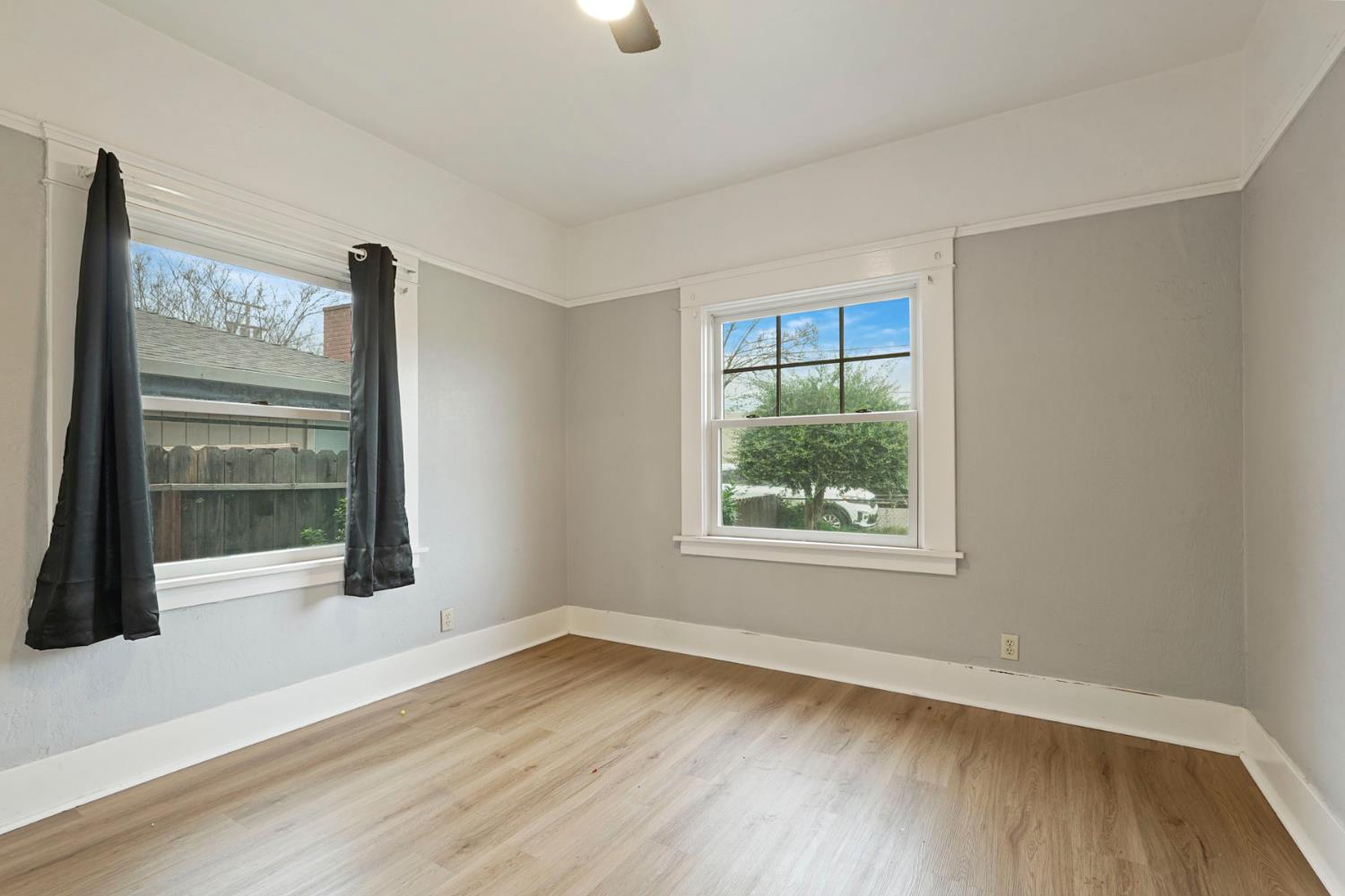 400 Chestnut Street Lodi, CA 95240 - Photo 14 of 36 a view of an empty room with wooden floor and a window