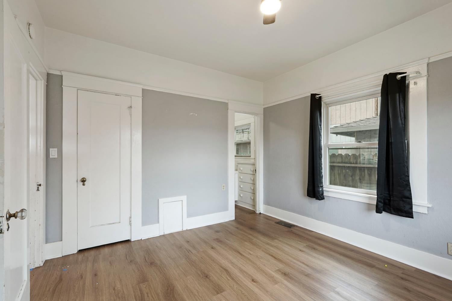400 Chestnut Street Lodi, CA 95240 - Photo 15 of 36 a view of an empty room with wooden floor and a window