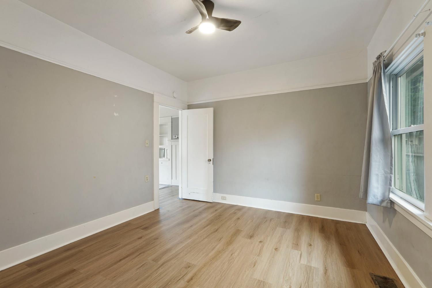 400 Chestnut Street Lodi, CA 95240 - Photo 20 of 36 an empty room with wooden floor cabinet and windows