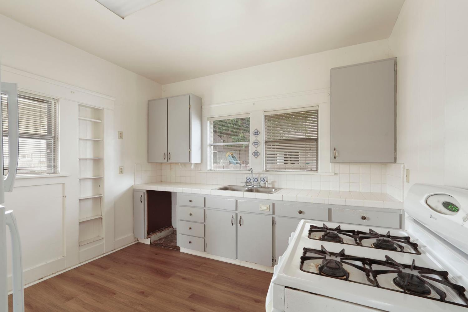 400 Chestnut Street Lodi, CA 95240 - Photo 24 of 36 a kitchen with sink a stove and cabinets