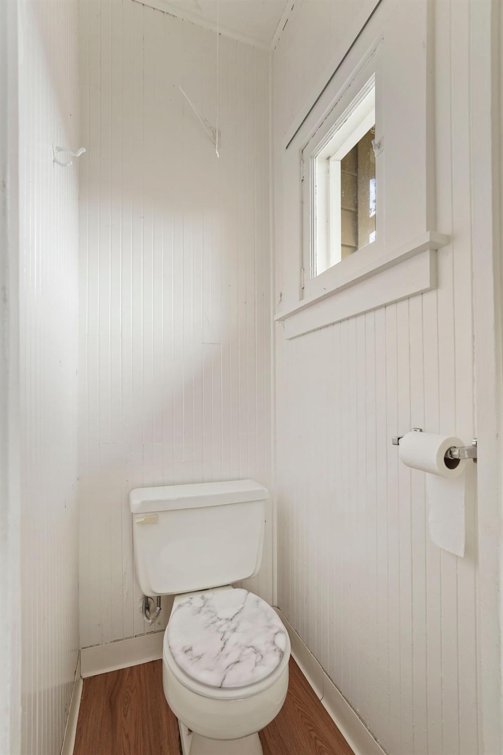 400 Chestnut Street Lodi, CA 95240 - Photo 29 of 36 a white toilet sitting next to a shower