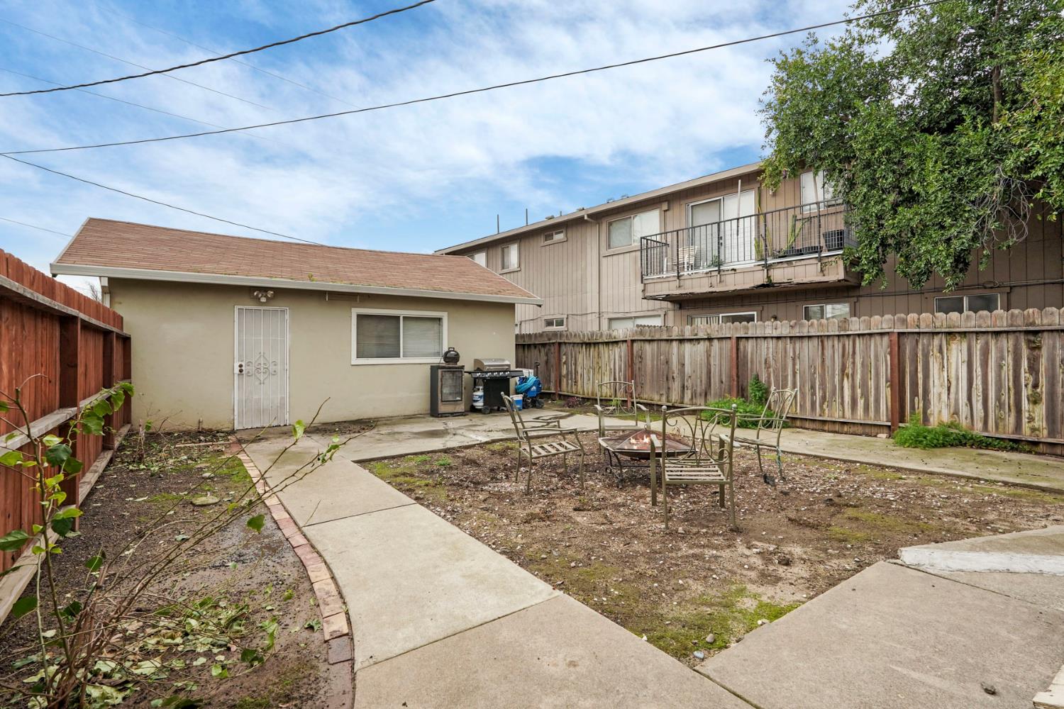 400 Chestnut Street Lodi, CA 95240 - Photo 30 of 36 a backyard of a house with yard fire pit and chairs