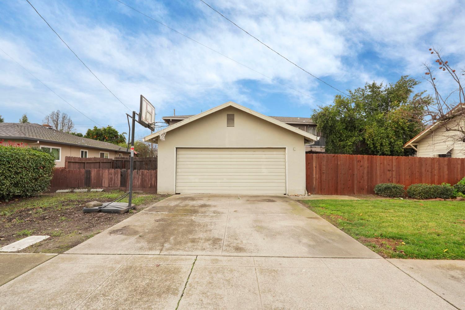 400 Chestnut Street Lodi, CA 95240 - Photo 7 of 36 a view of a house with a yard and garage