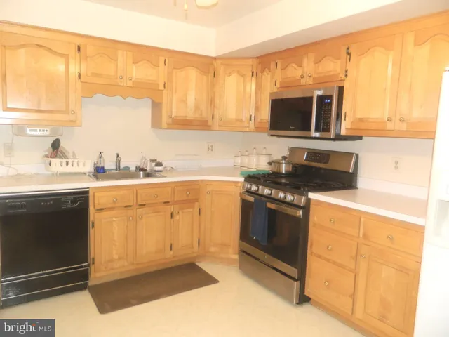a white refrigerator freezer sitting inside of a kitchen