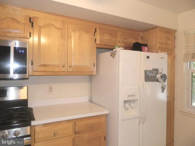 a white refrigerator freezer sitting in a kitchen