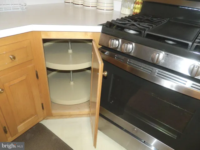 a stove top oven sitting inside of a kitchen