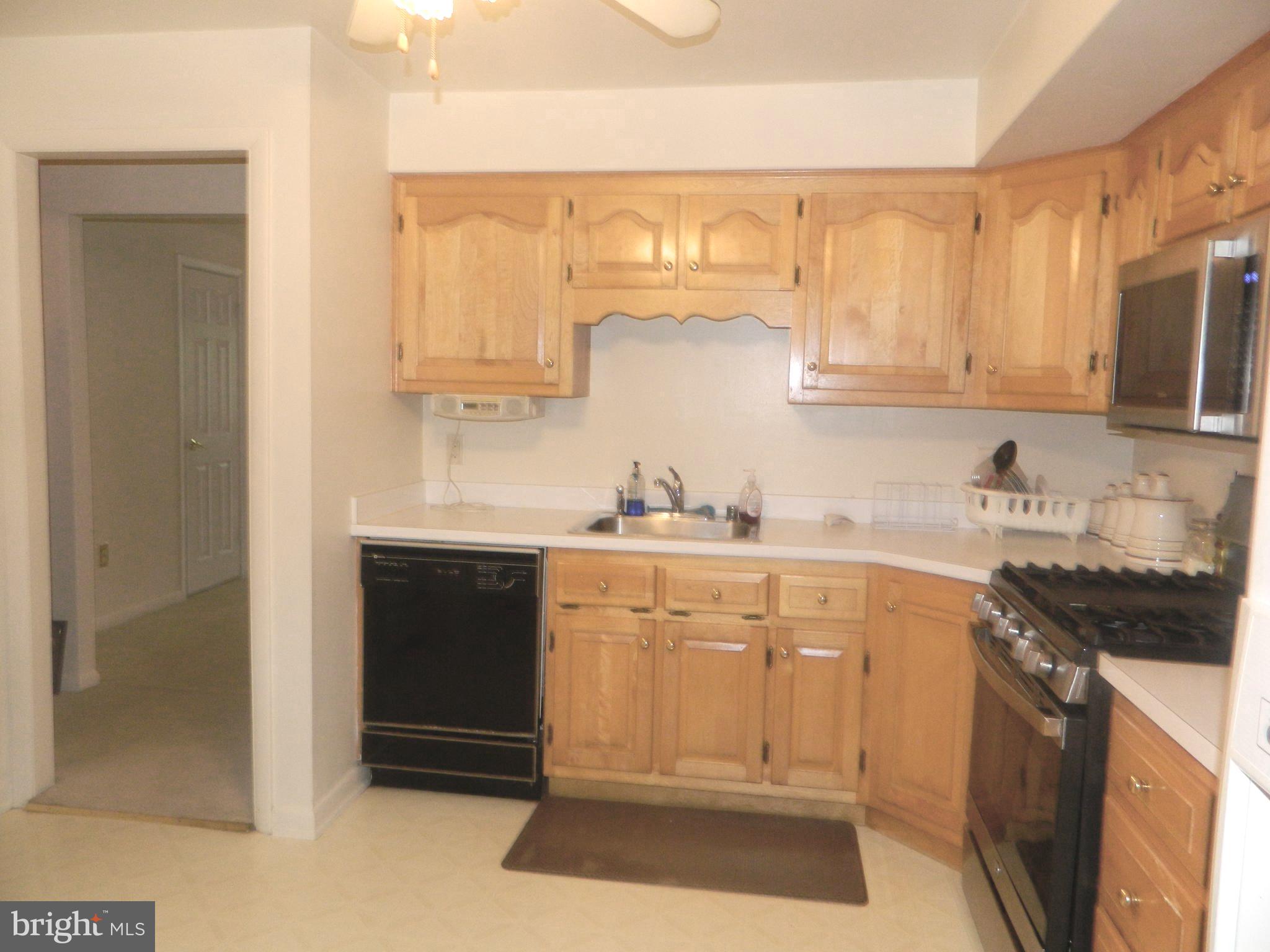 17 Theo Lane, Unit 17 Towson, MD 21204 - Photo 9 of 54 a kitchen with granite countertop white cabinets and white appliances