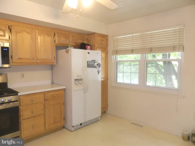 a kitchen with stainless steel appliances a stove microwave and sink