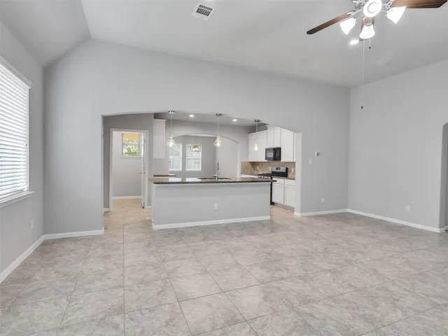 a view of kitchen with refrigerator and window