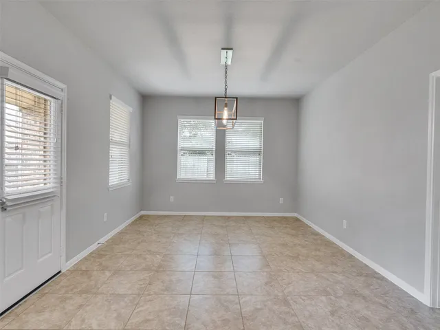 a view of a big room with windows and chandelier
