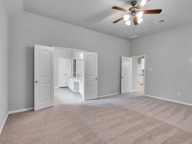 a bathroom with a granite countertop sink a mirror and a bathtub