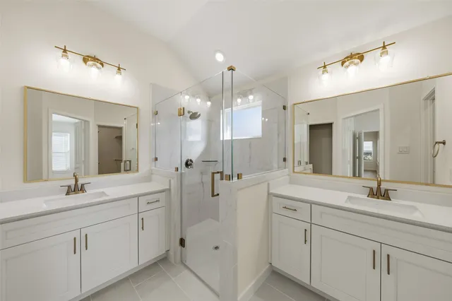 a spacious bathroom with a double vanity sink mirror and